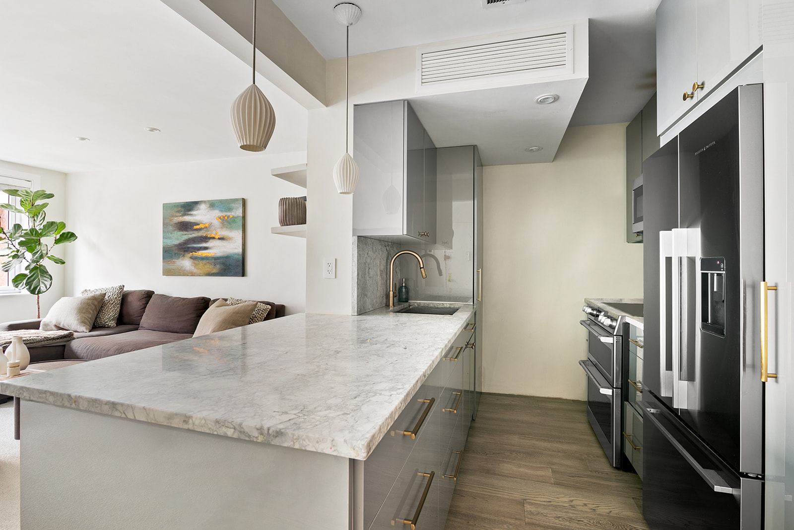 712 Washington Street, Unit 2A Manhattan, NY 10014 - Photo 2 of 8 a kitchen with stainless steel appliances granite countertop a sink a oven and a refrigerator