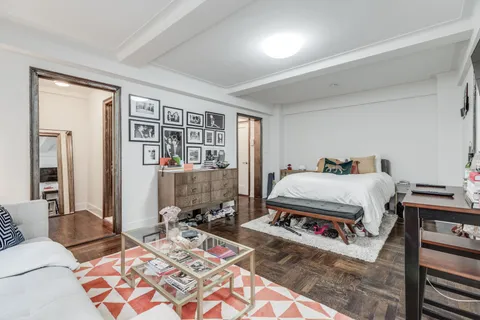 a bedroom with a bed a table and chair