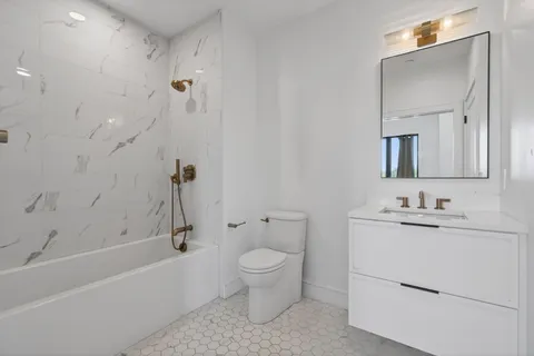 a bathroom with a toilet a sink and bathtub