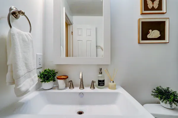a bathroom with a sink a vanity and a mirror