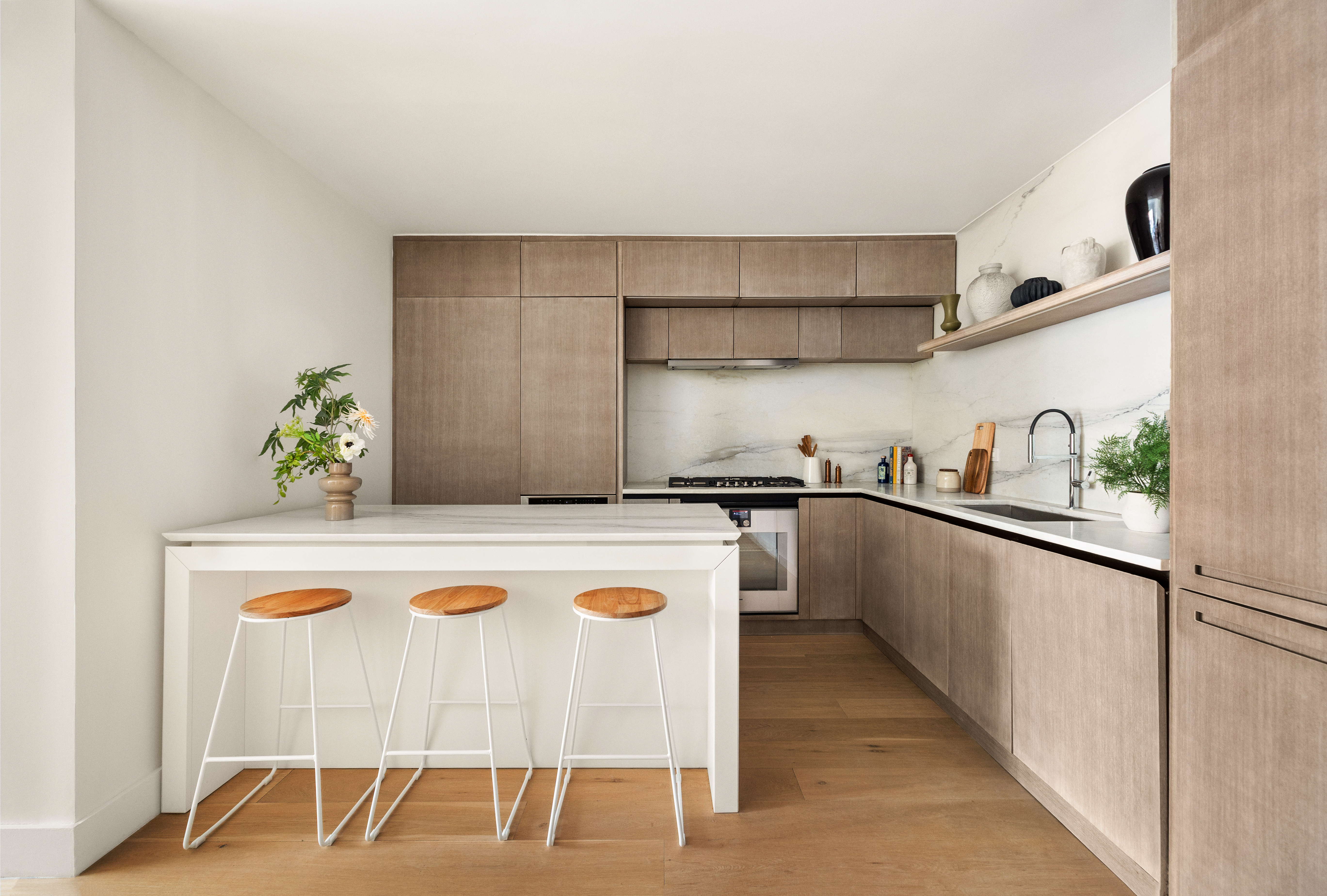 225 14th Street, Unit GARDEN A Brooklyn, NY 11215 - Photo 3 of 13 a kitchen with kitchen island white cabinets and white appliances