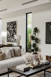 a living room with furniture and a potted plant