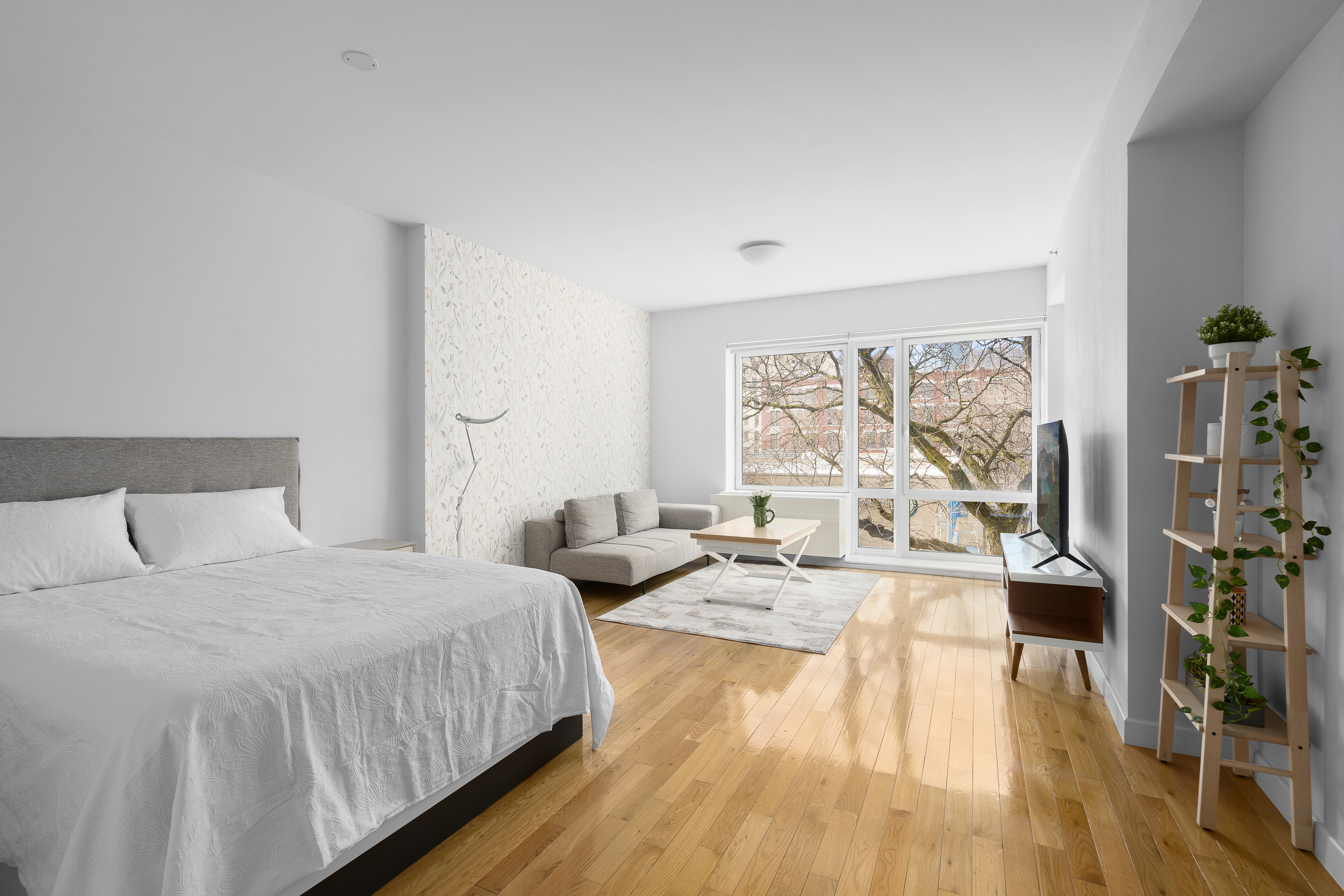 454 West 54th Street, Unit 3N Manhattan, NY 10019 - Photo 1 of 7 a bedroom with a bed and a wooden floor