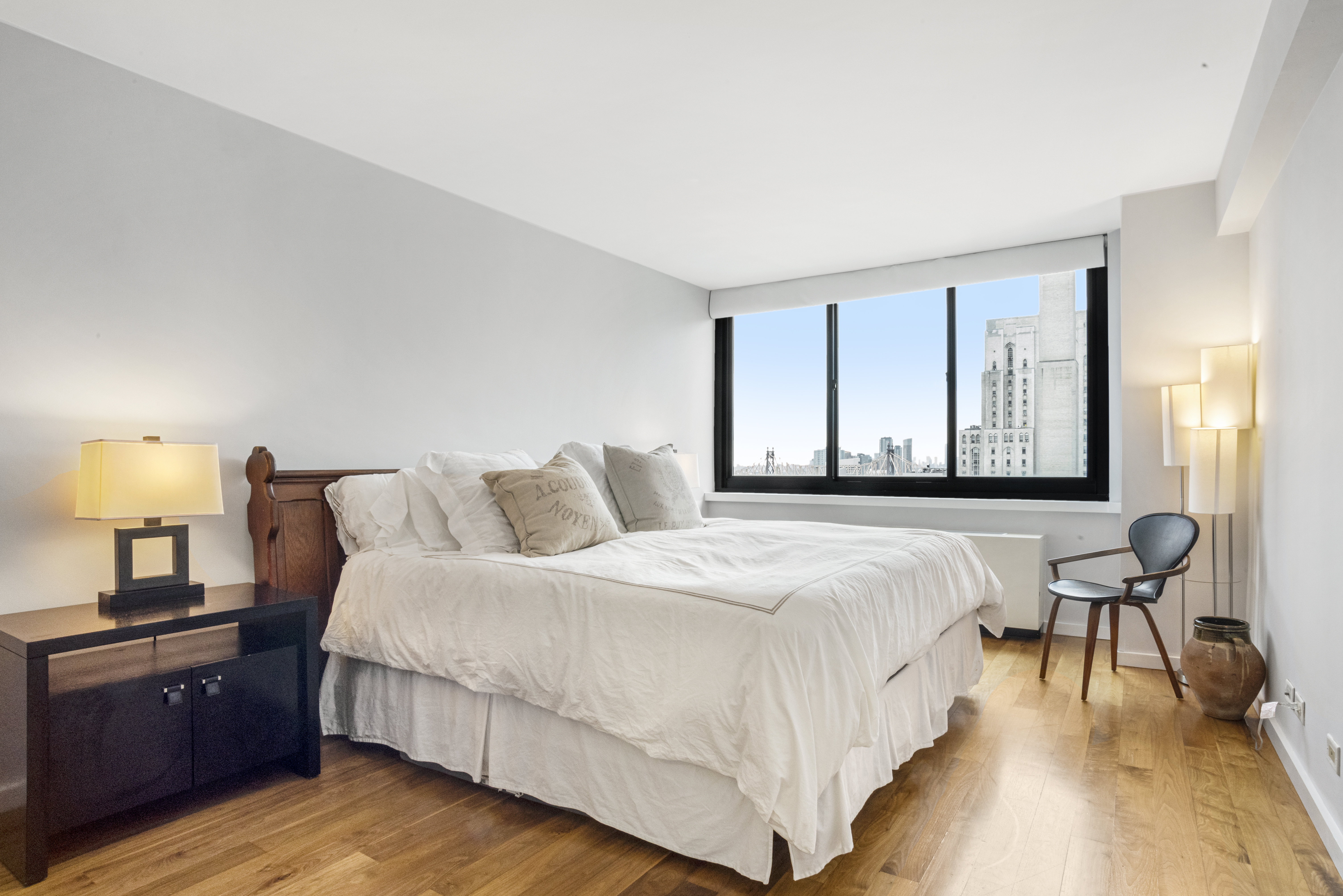 515 East 72nd Street, Unit 25E Manhattan, NY 10021 - Photo 4 of 11 a bedroom with a bed and wooden floor