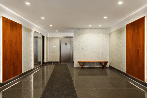 a view of a hallway with seating area