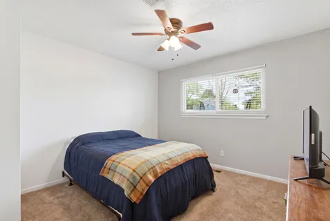 a bedroom with a bed and a window