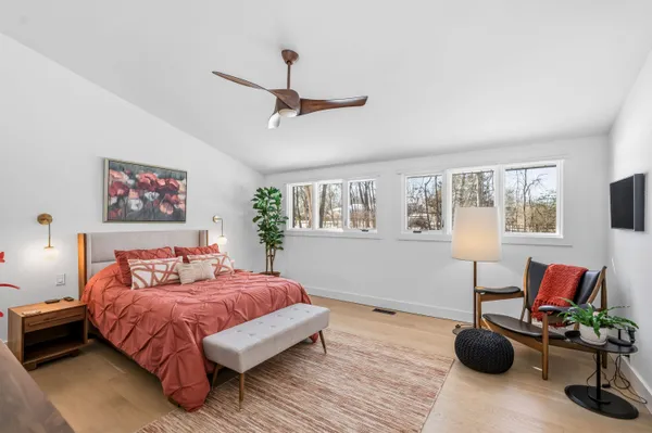 a bedroom with a bed furniture and a window
