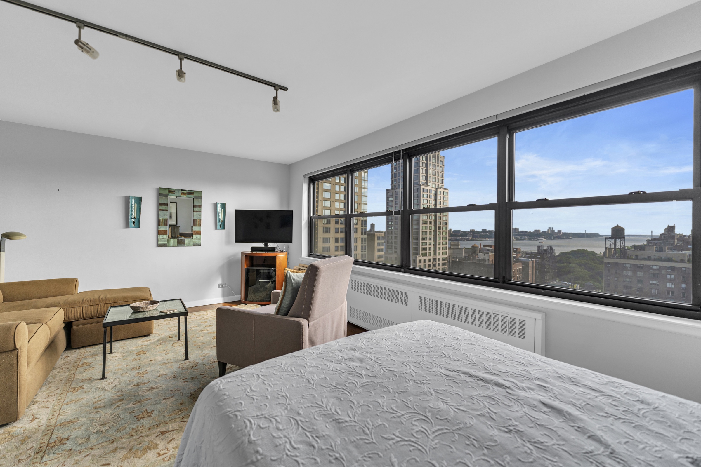 205 West End Avenue, Unit 23E Manhattan, NY 10023 - Photo 6 of 15 a living room with furniture and a large window