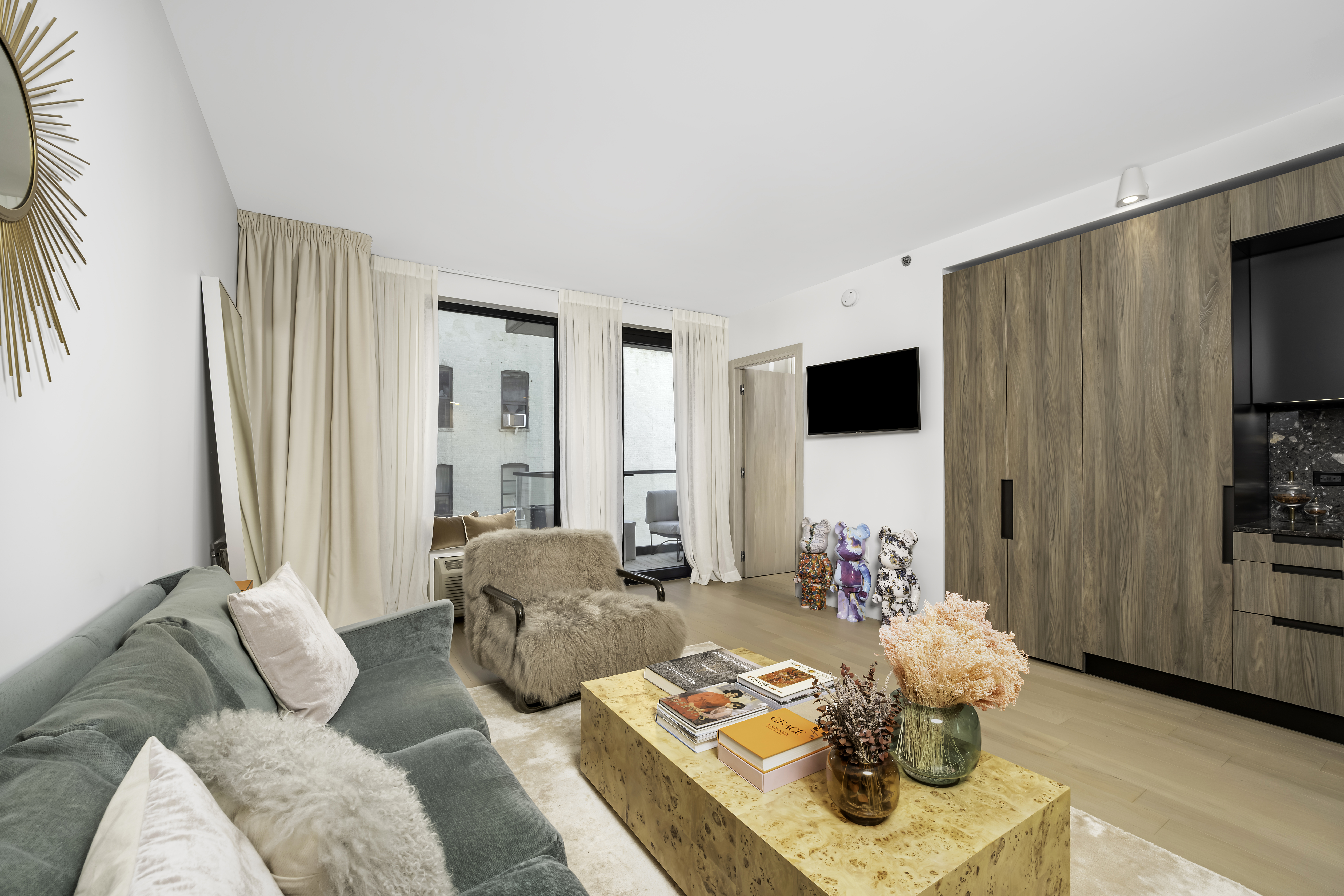 181 East 101st Street, Unit 701 Manhattan, NY 10029 - Photo 2 of 16 a living room with furniture and a flat screen tv