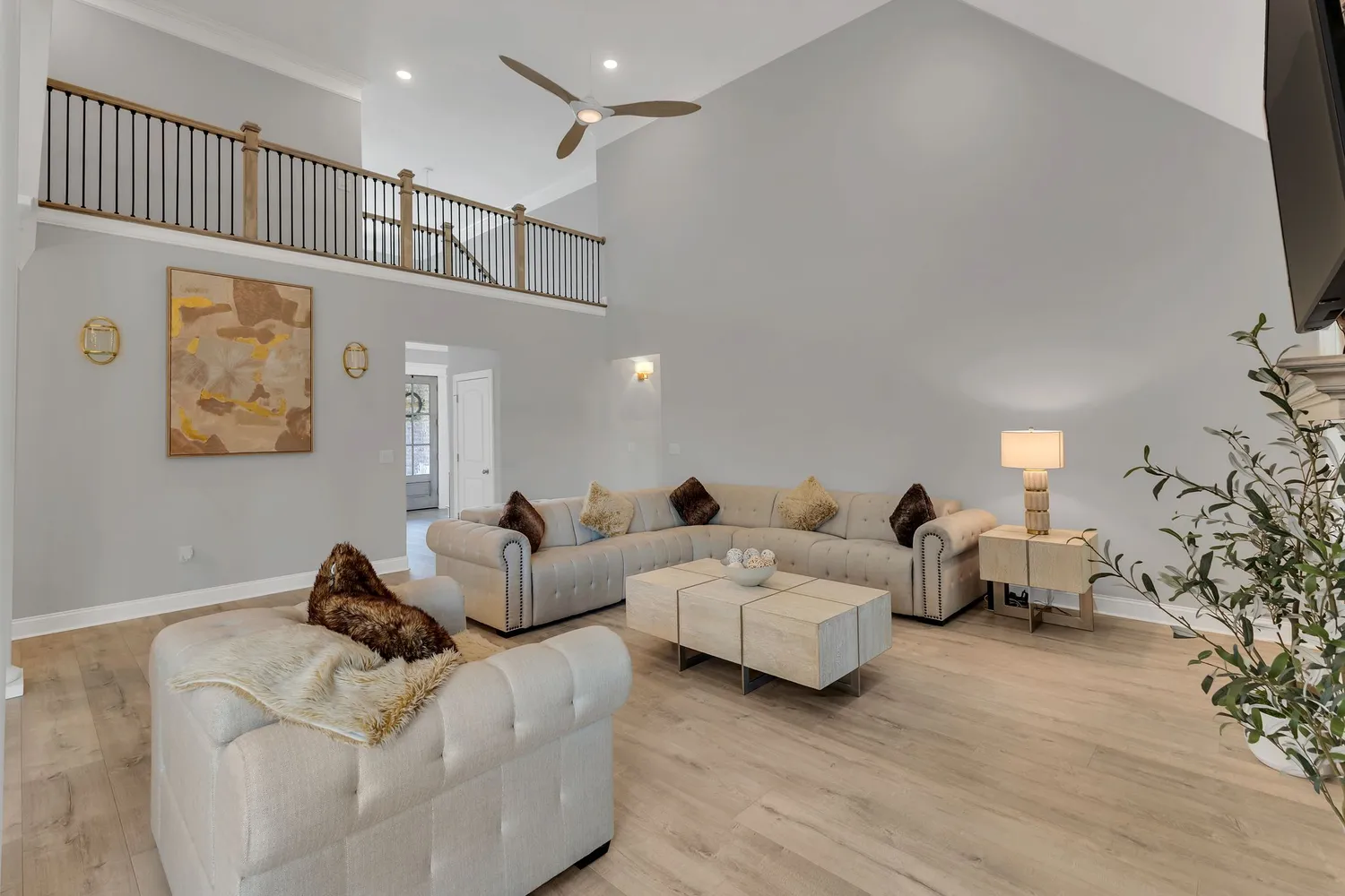 a living room with furniture and a chandelier