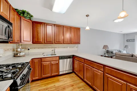 a kitchen with a sink stove and cabinets