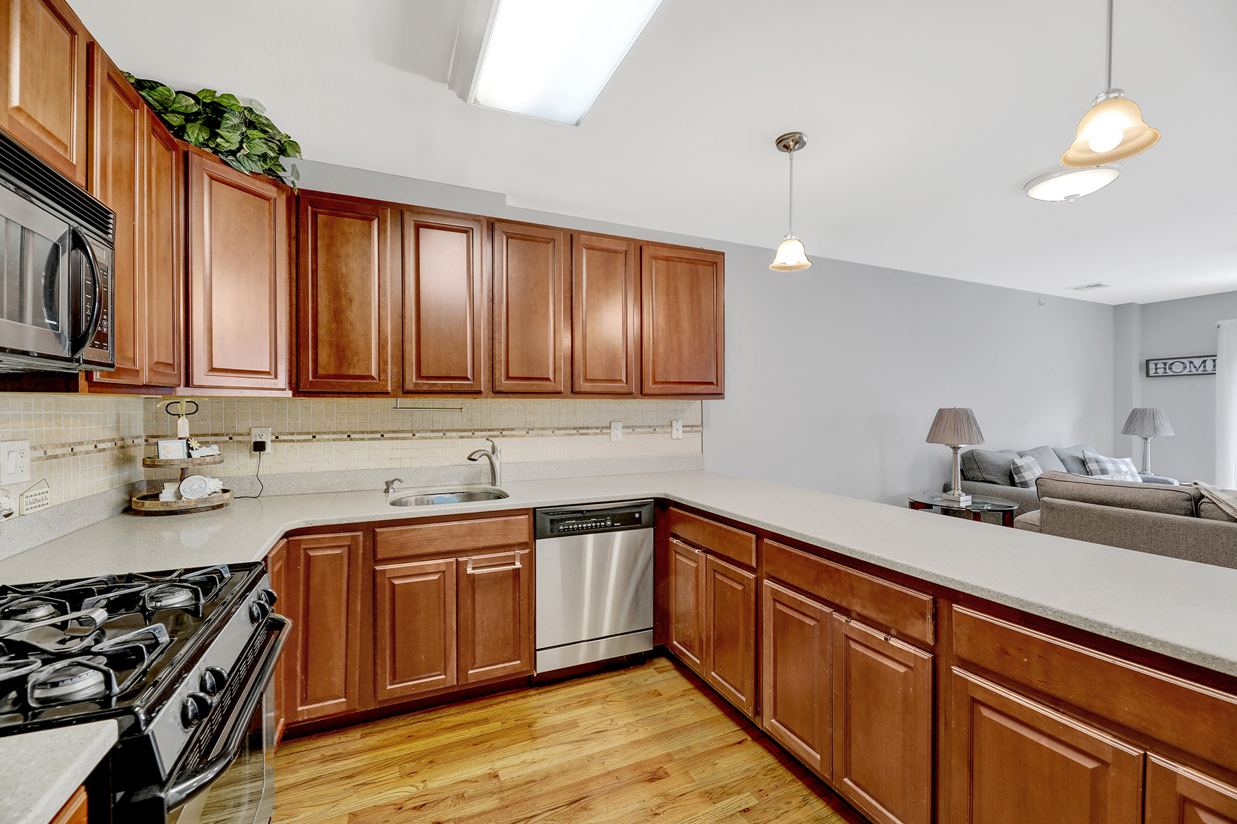 10220 Rockaway Beach Boulevard, Unit 3C Queens, NY 11694 - Photo 10 of 46 a kitchen with a sink stove and cabinets