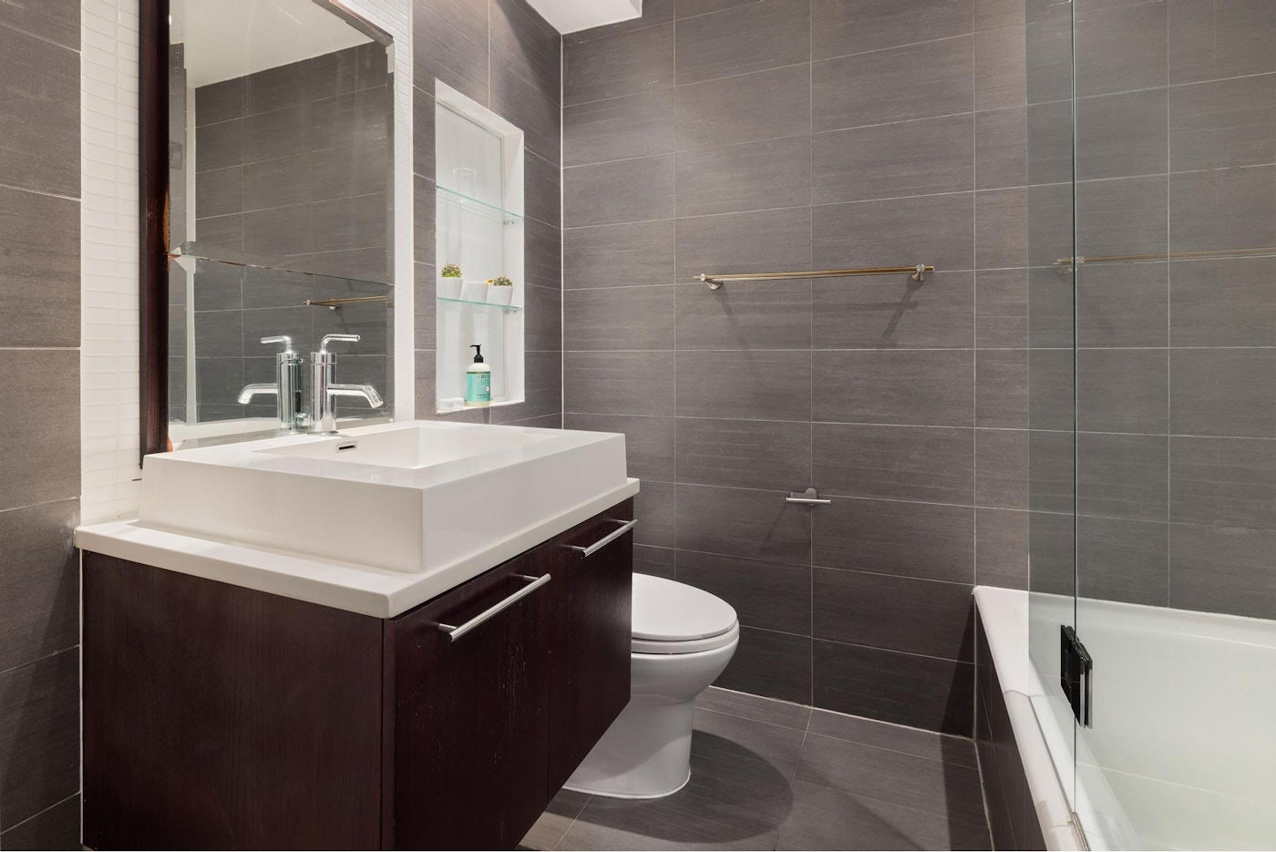 662 Bergen Street, Unit 1A Brooklyn, NY 11238 - Photo 4 of 9 a bathroom with a sink a toilet and a mirror