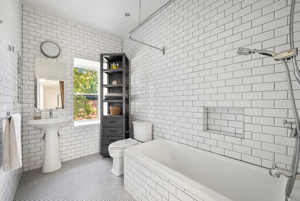 a bathroom with a bathtub and shower