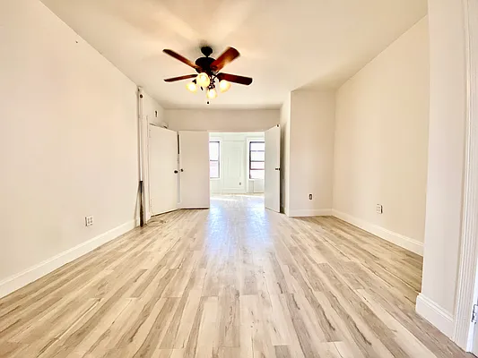 591 Vanderbilt Avenue, Unit 4 Brooklyn, NY 11238 - Photo 3 of 10 a view of empty room with wooden floor and window