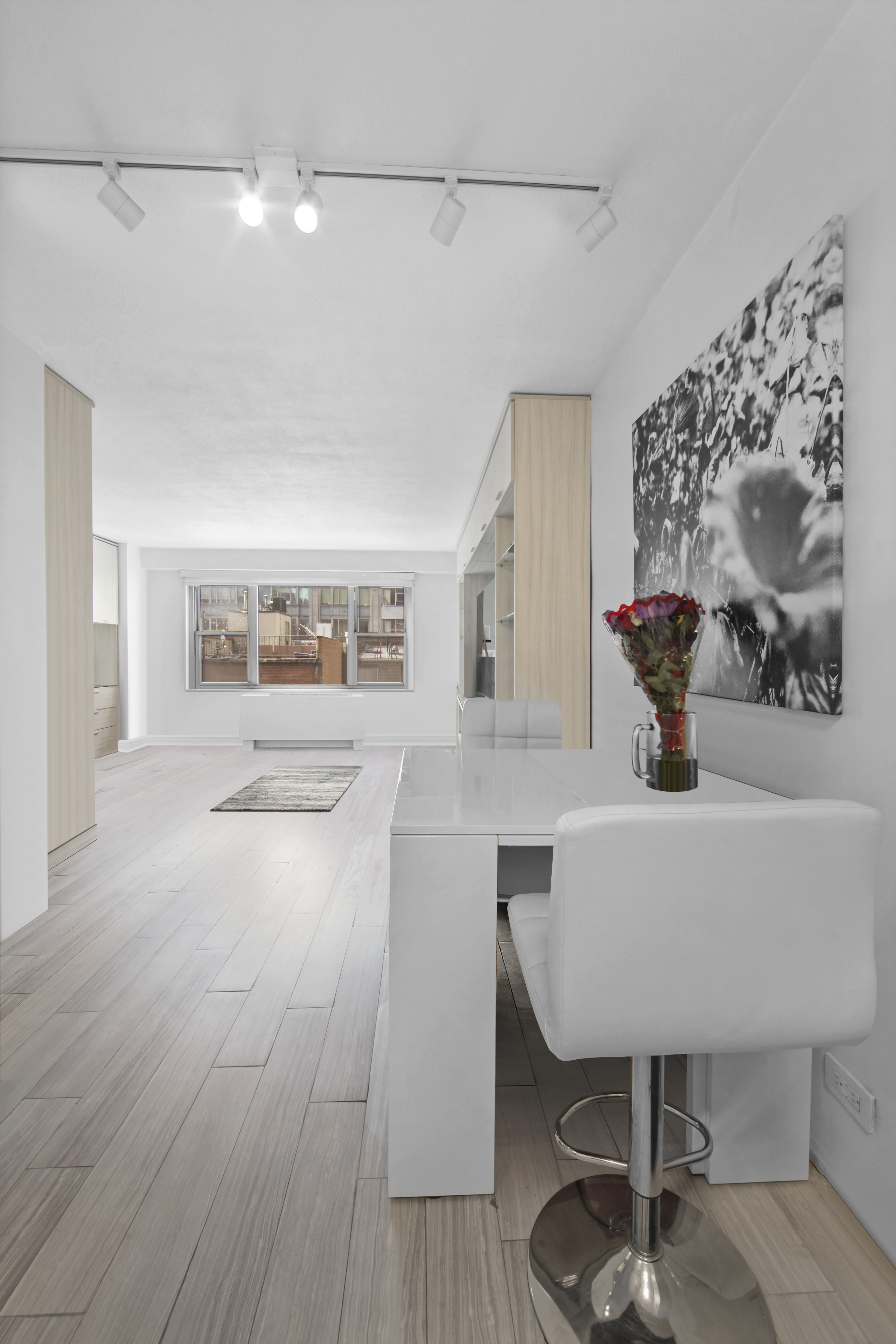 220 East 60th Street, Unit 5F Manhattan, NY 10022 - Photo 3 of 8 a view of dining room with furniture and wooden floor