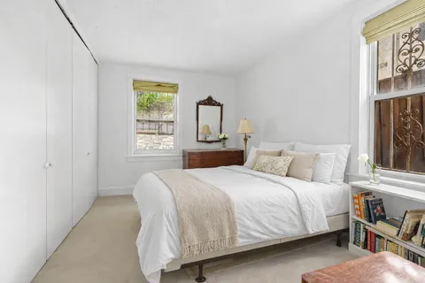 a bedroom with a bed and window