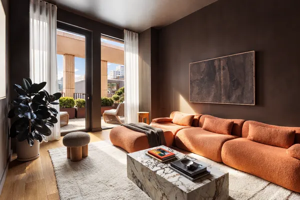 a living room with furniture and a floor to ceiling window