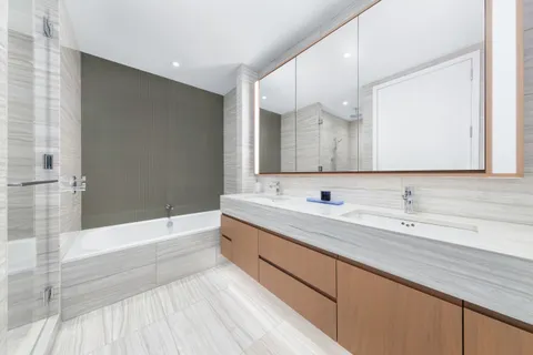 a bathroom with a sink a mirror and a bathtub