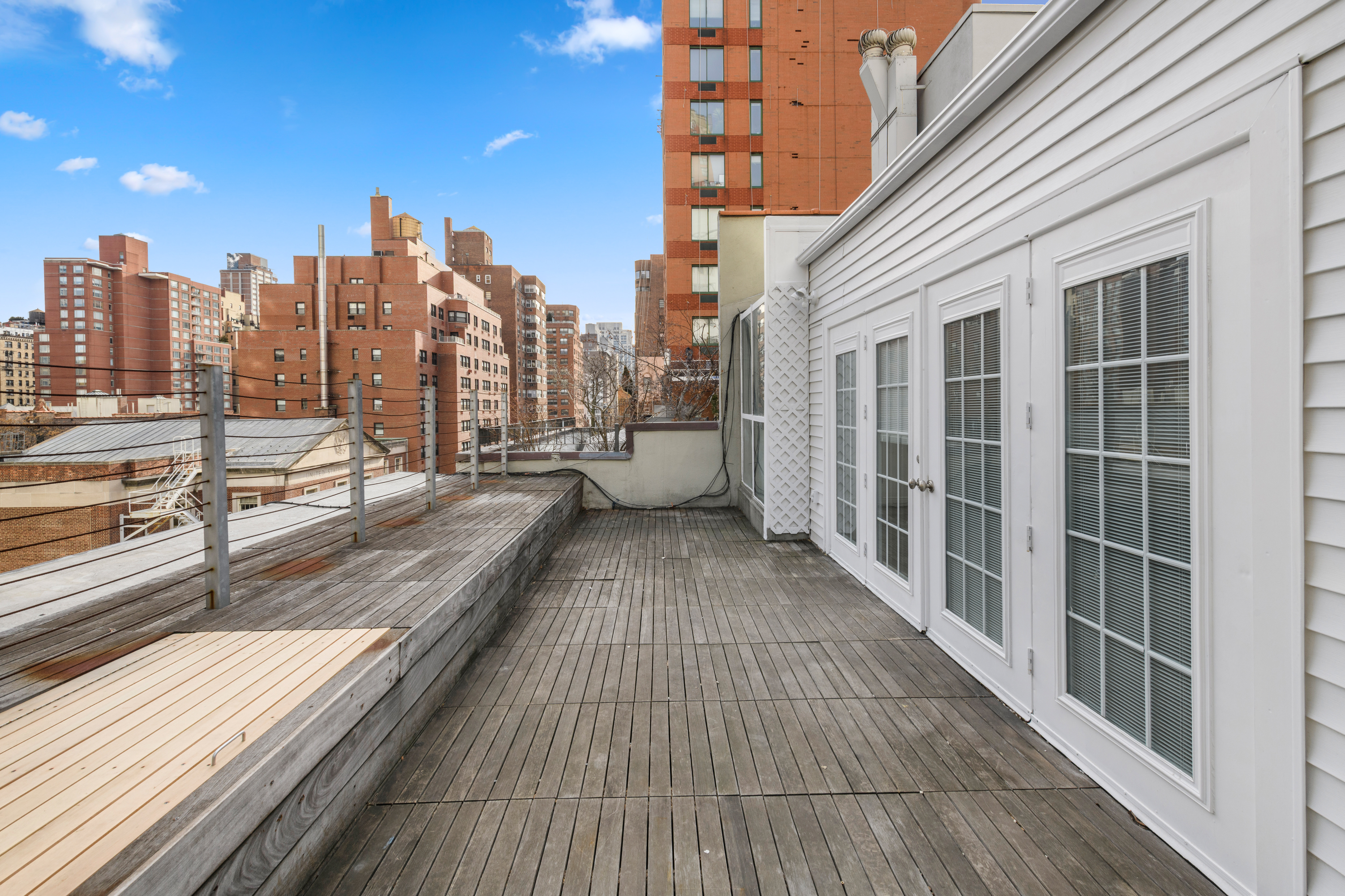 212 East 70th Street, Unit 4B Manhattan, NY 10021 - Photo 3 of 16 a view of balcony with wooden floor and city view