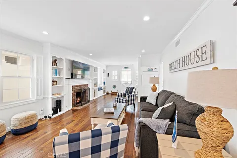a living room with furniture fireplace and a window
