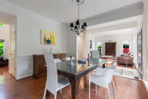 a view of a dining room with furniture wooden floor and a chandelier