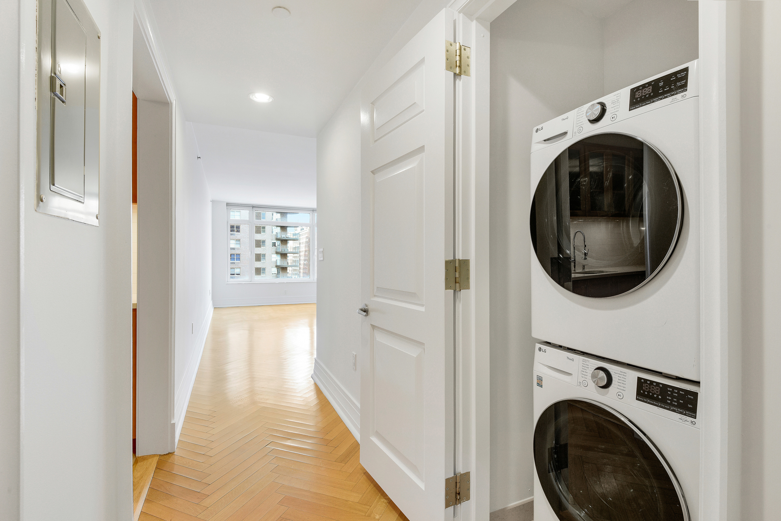 205 East 85th Street, Unit 12H Manhattan, NY 10028 - Photo 10 of 19 a view of a hallway with washer and dryer