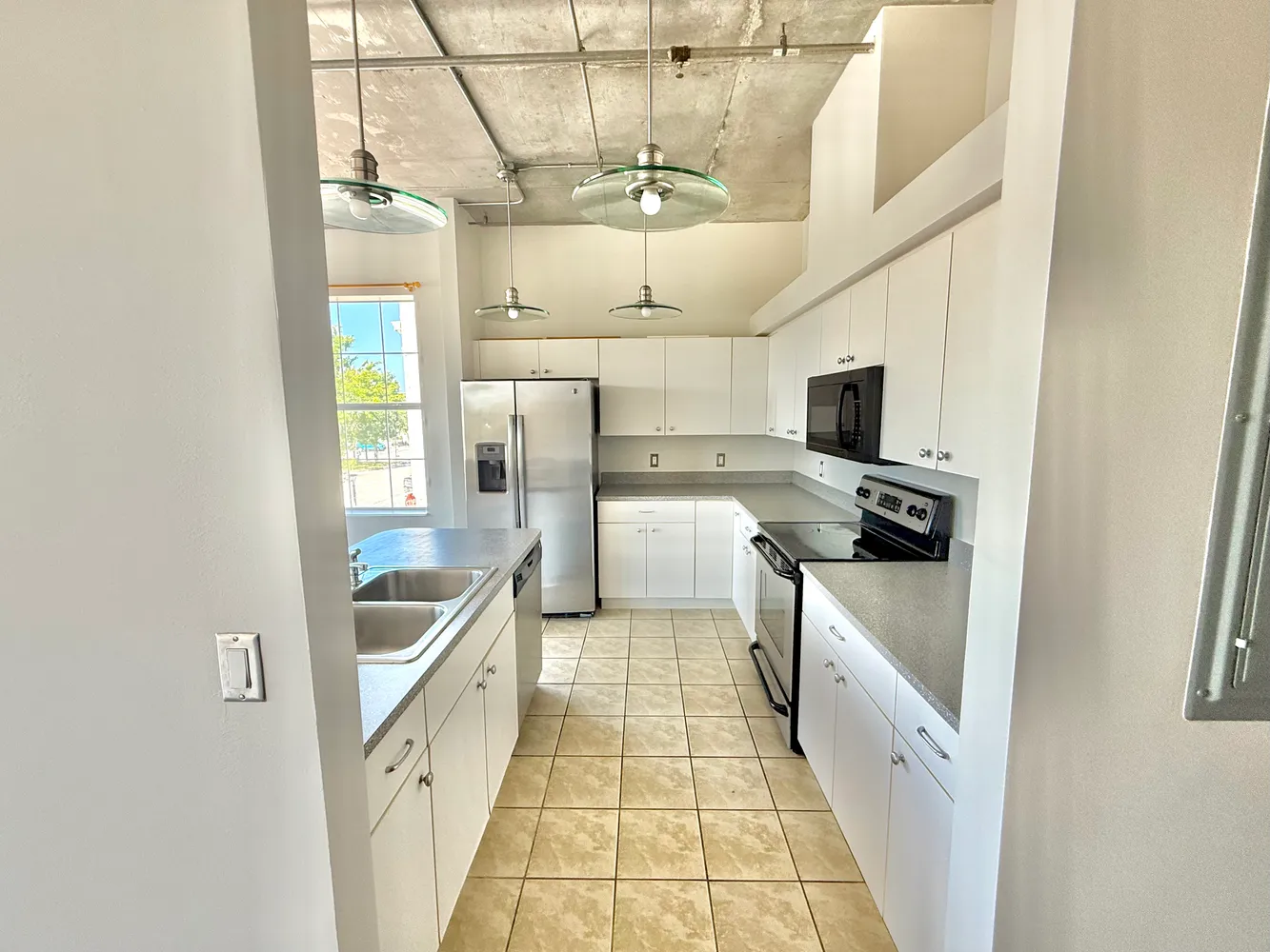 a kitchen with stainless steel appliances a stove a refrigerator and a microwave