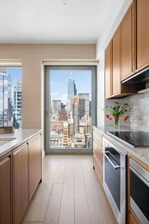 a kitchen with stainless steel appliances granite countertop a refrigerator and a stove