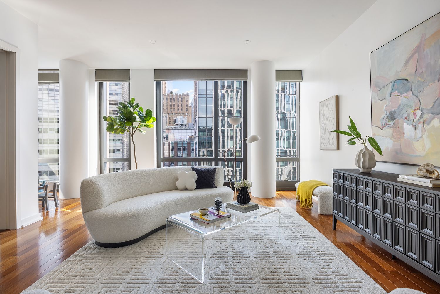 a living room with furniture and wooden floor