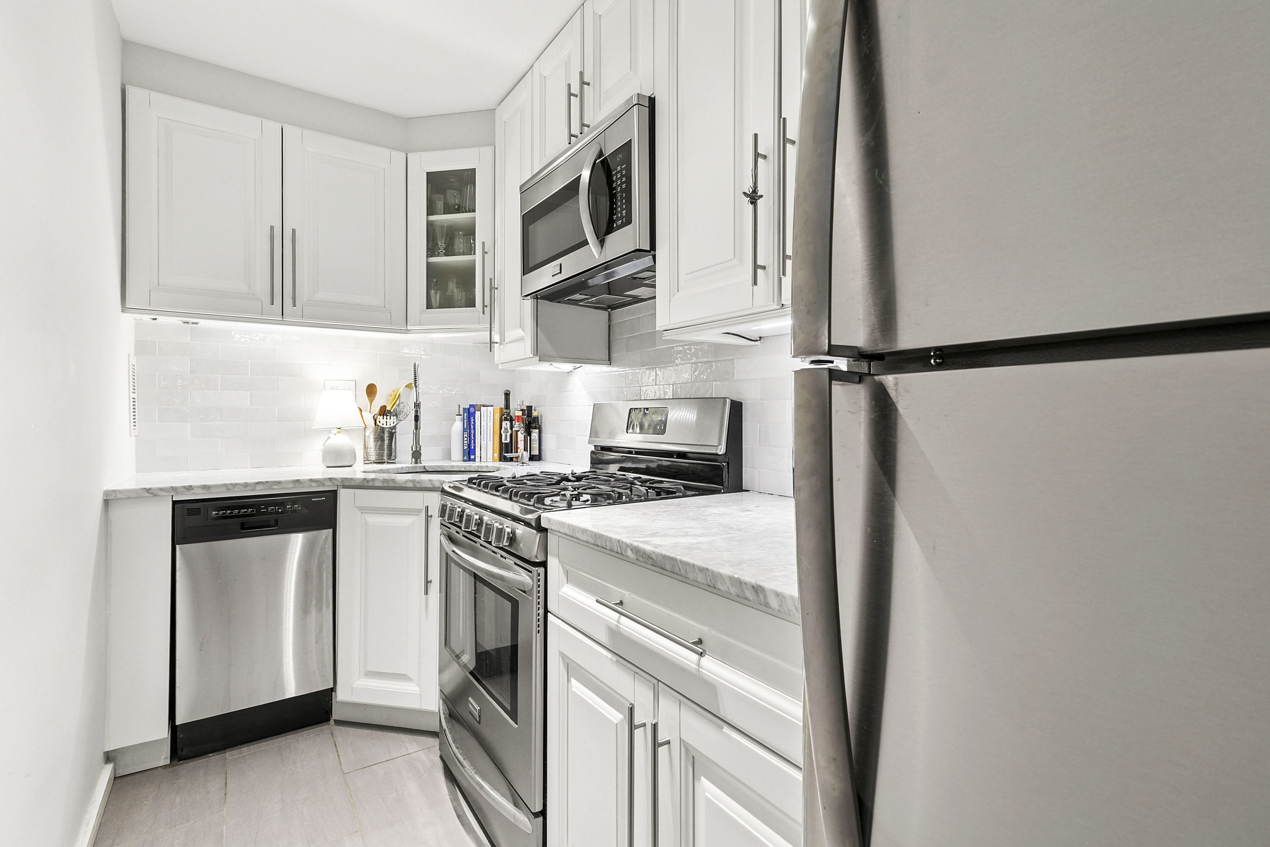 185 West Houston Street, Unit 4H Manhattan, NY 10014 - Photo 3 of 11 a kitchen with a sink stove and microwave