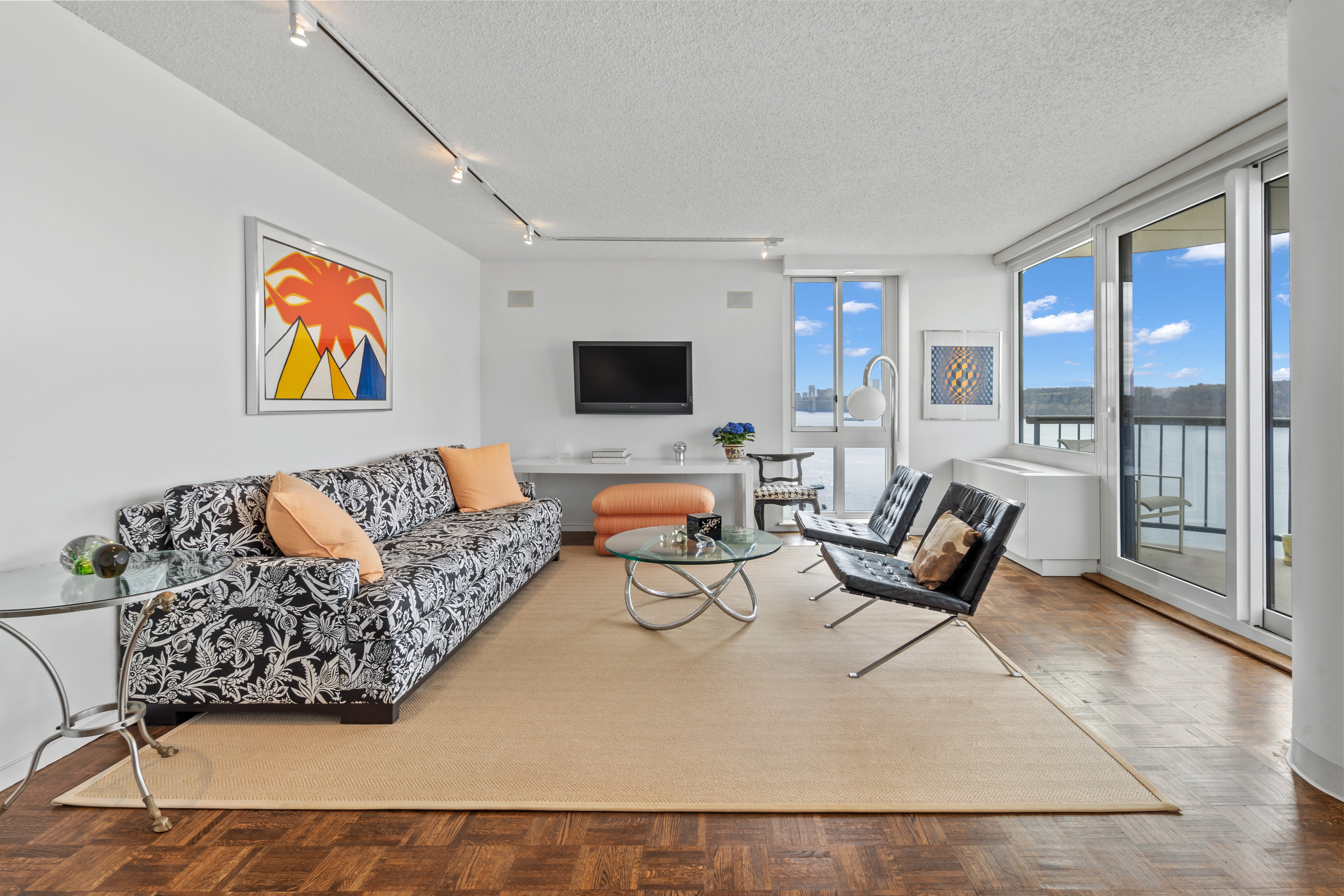 2521 Palisade Avenue, Unit 10A Bronx, NY 10463 - Photo 3 of 17 a living room with furniture and large window with garden view