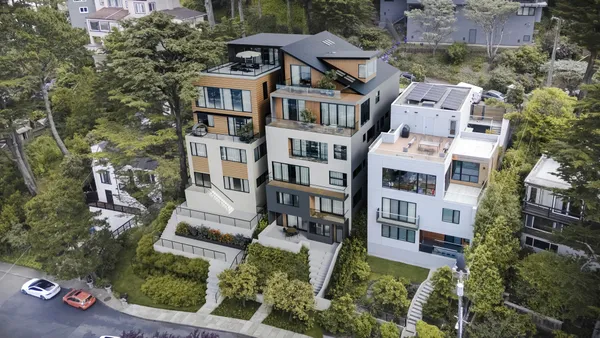 an aerial view of residential houses with outdoor space