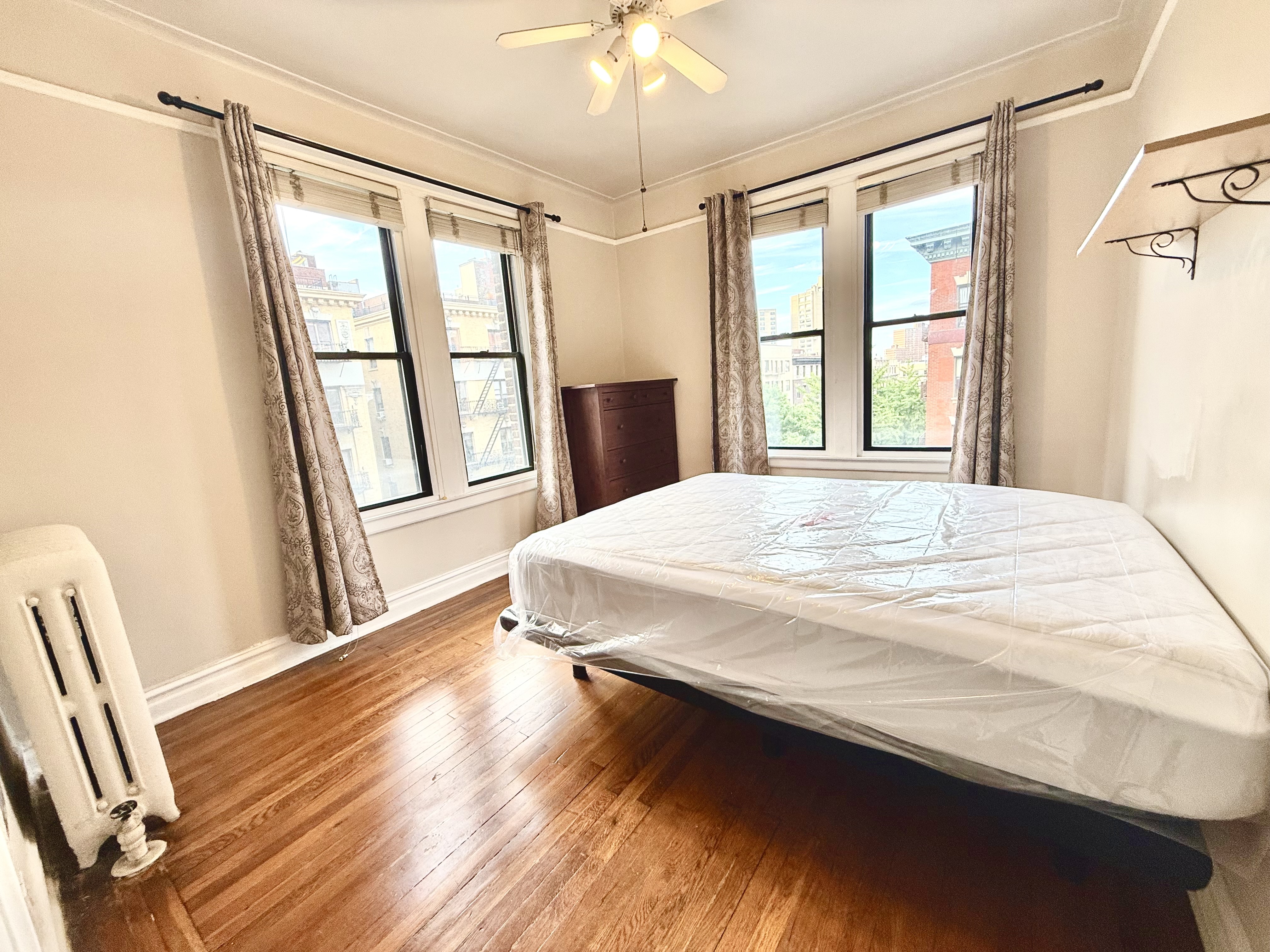 170 Claremont Avenue, Unit 19 Manhattan, NY 10027 - Photo 4 of 9 a bedroom with a bed and a window