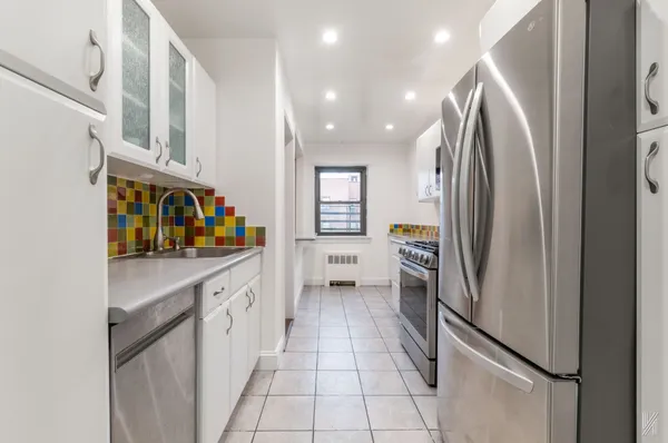 a kitchen with stainless steel appliances granite countertop a refrigerator and a stove