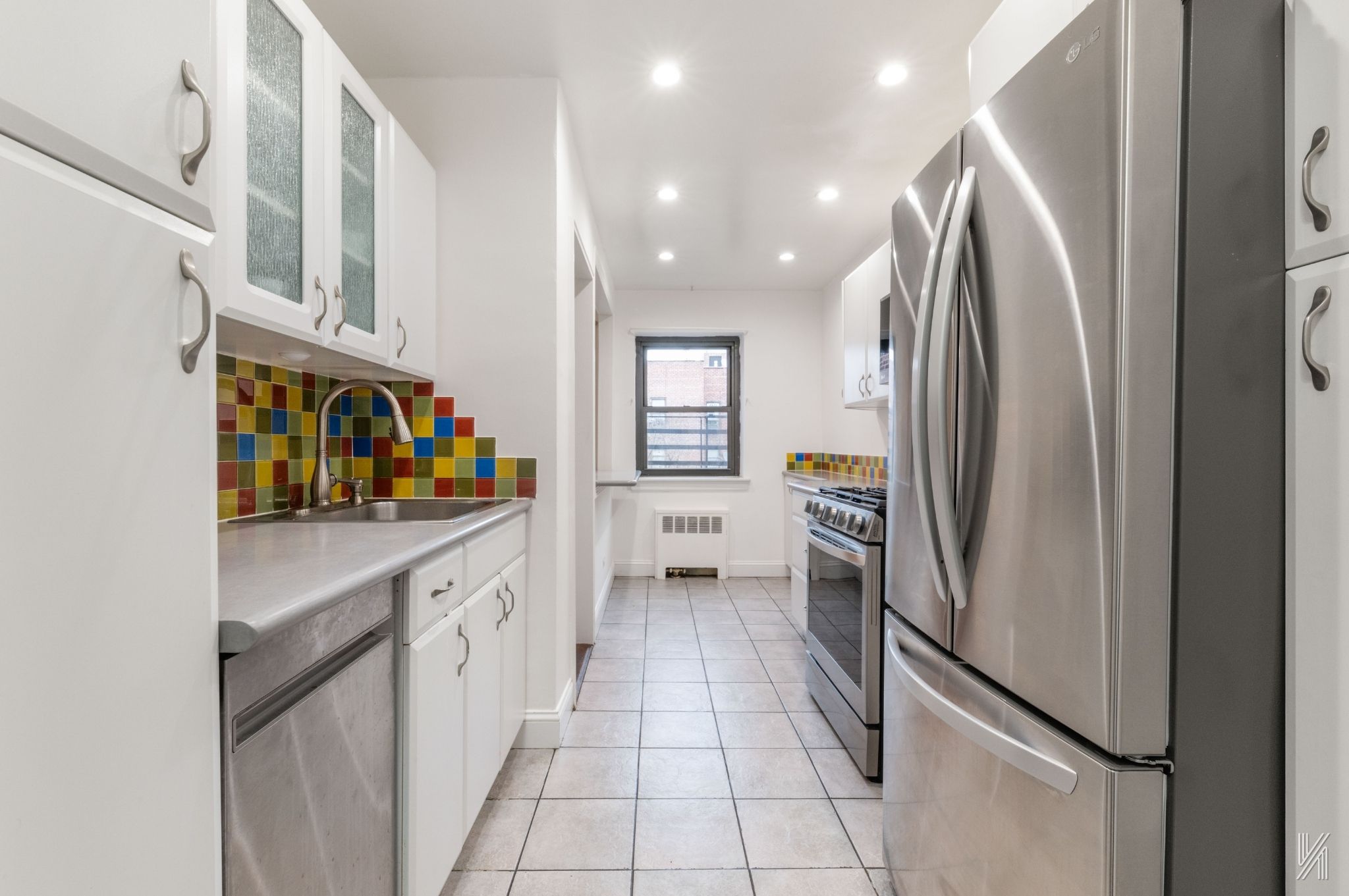 34-10 94th Street, Unit 6G Queens, NY 11372 - Photo 2 of 19 a kitchen with stainless steel appliances granite countertop a refrigerator and a stove