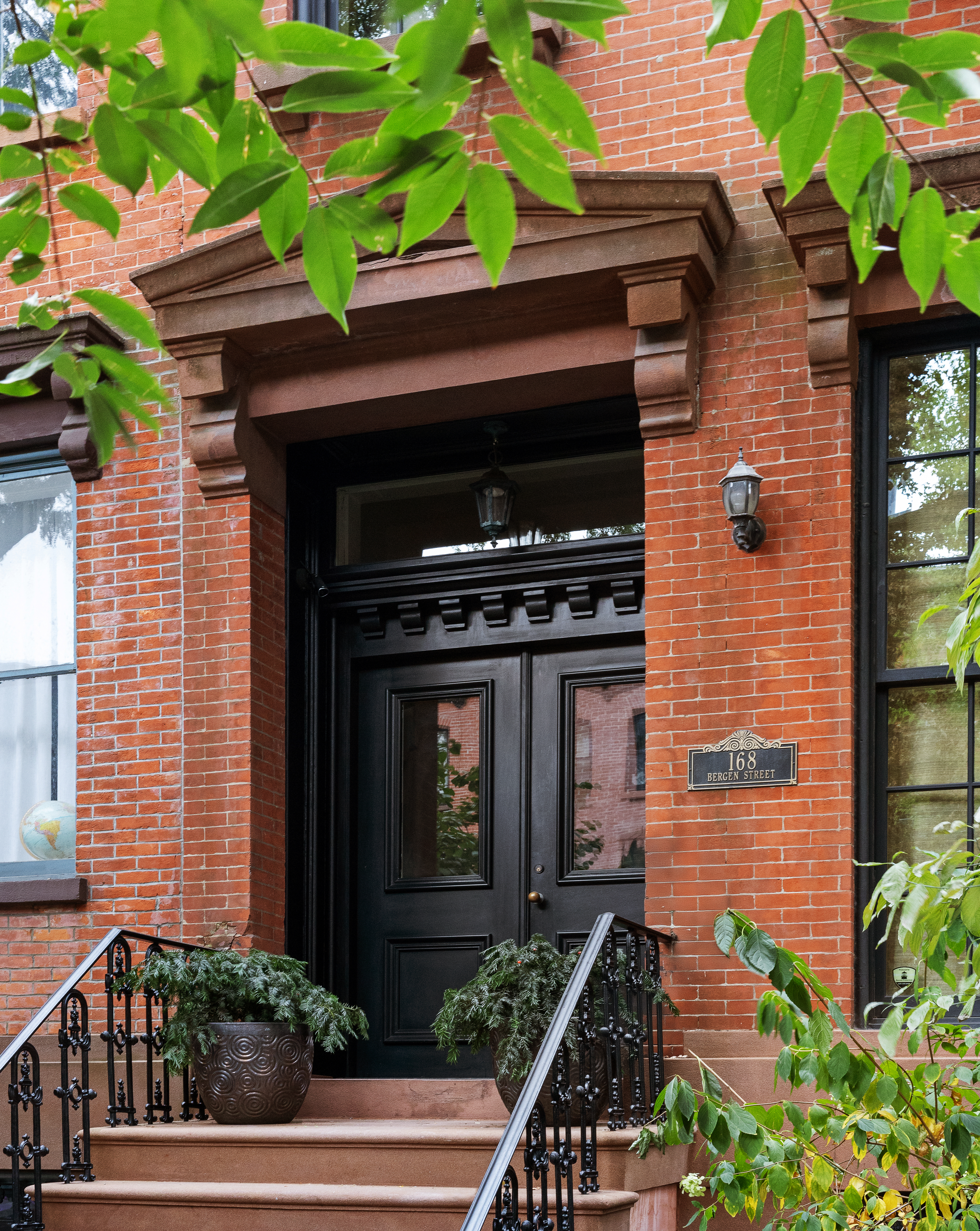 168 Bergen Street Brooklyn, NY 11217 - Photo 2 of 25 a brick building with potted plants in front of door