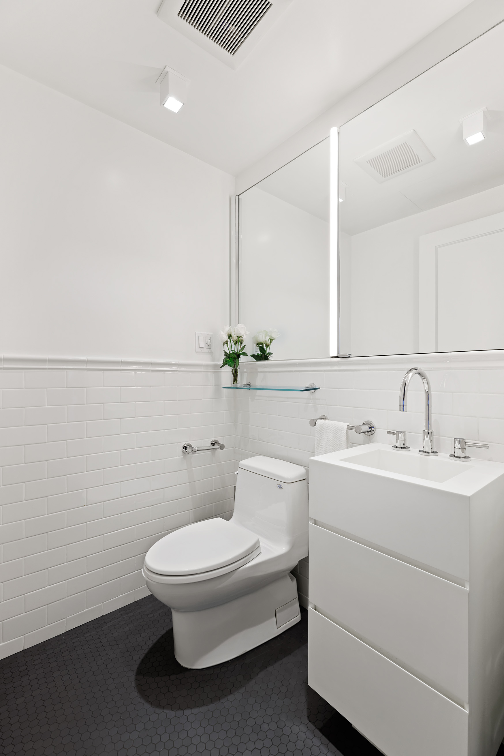 863 Park Avenue, Unit 8W Manhattan, NY 10075 - Photo 7 of 15 a bathroom with a toilet a sink and mirror