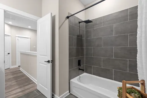 a bathroom with a bathtub and a shower