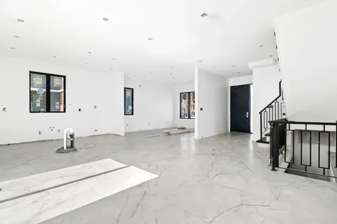 a view of a livingroom with wooden floor and staircase