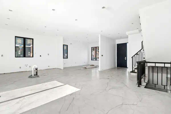 a view of a livingroom with wooden floor and staircase