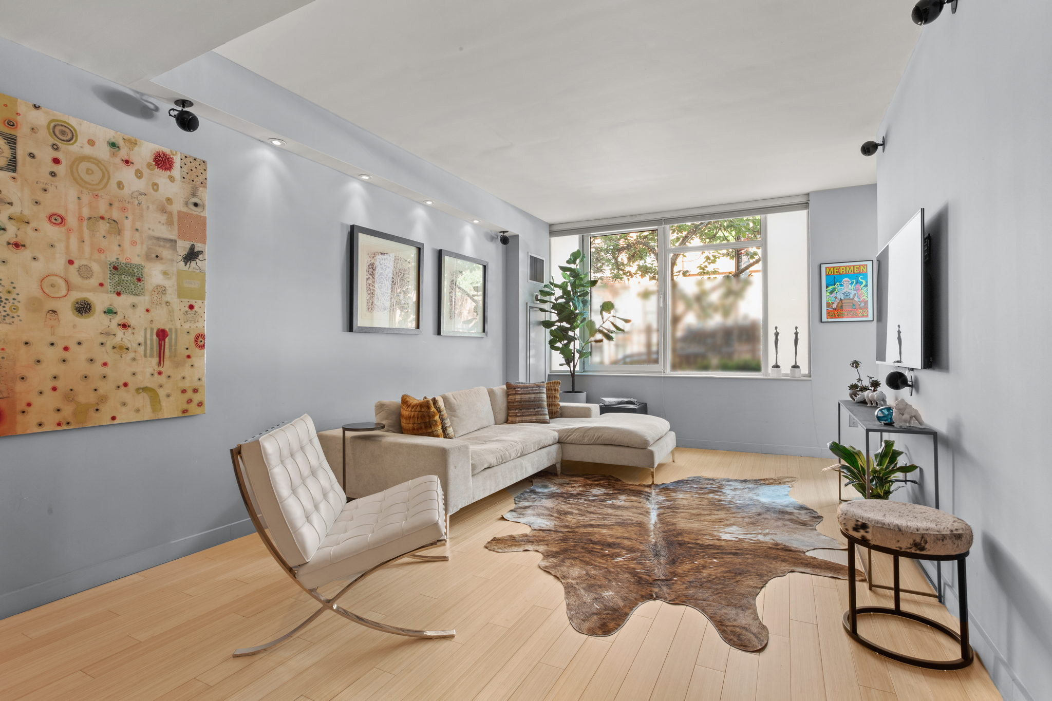350 West 53rd Street, Unit THG Manhattan, NY 10019 - Photo 2 of 25 a living room with furniture and a large window