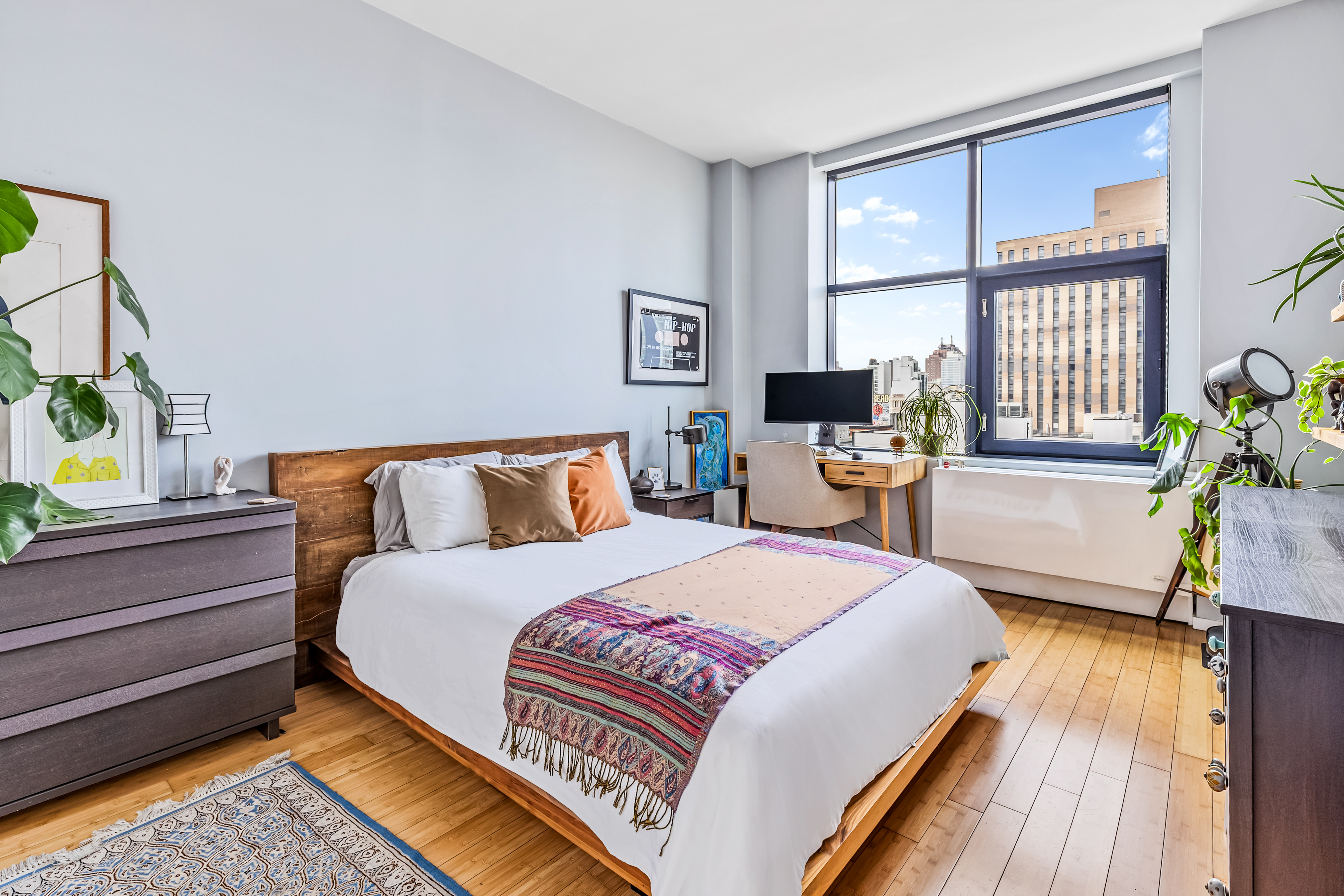 105 Norfolk Street, Unit 10A Manhattan, NY 10002 - Photo 6 of 11 a bedroom with a bed and wooden floor