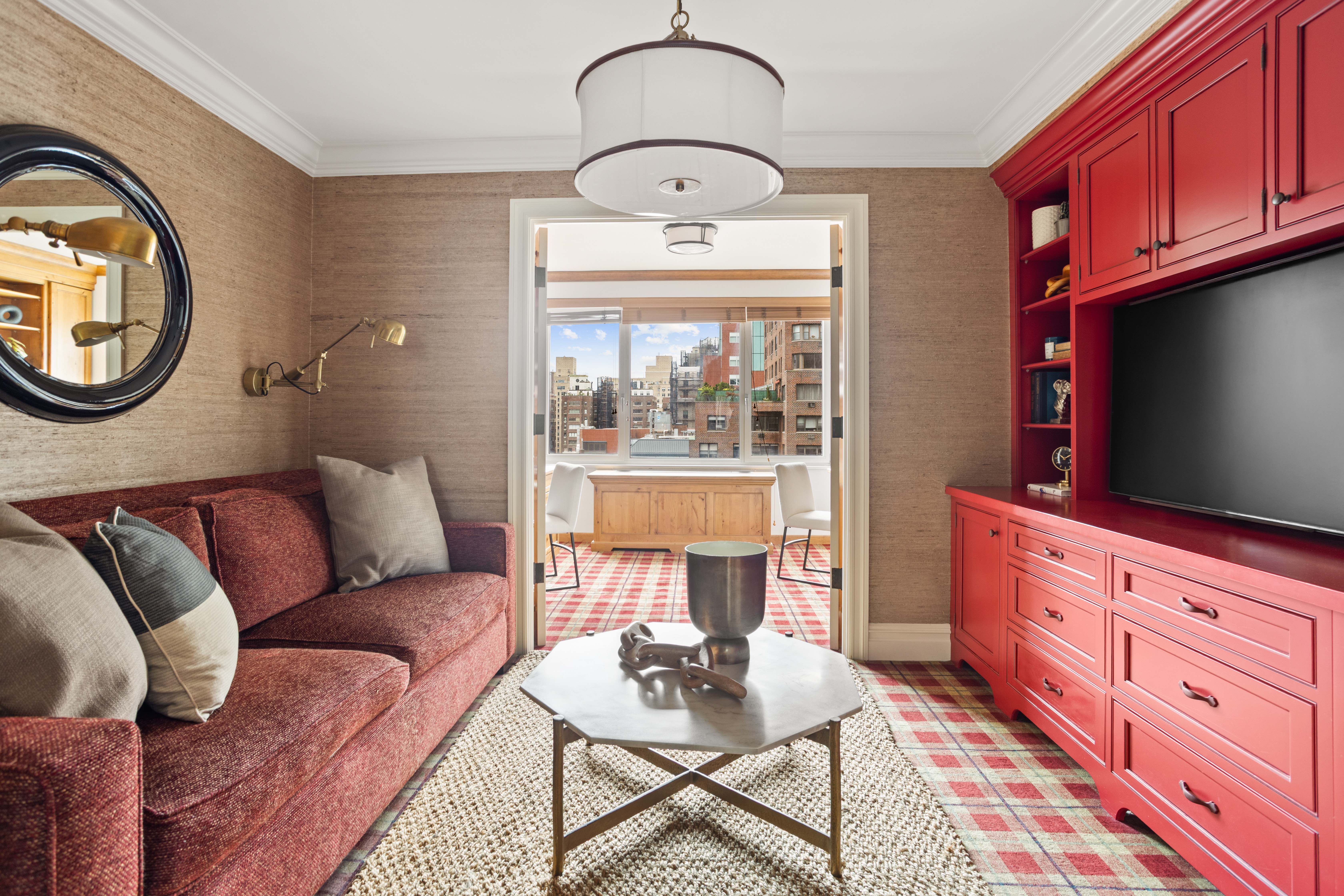 60 East End Avenue, Unit 12C Manhattan, NY 10028 - Photo 14 of 27 a living room with furniture a flat screen tv and a window