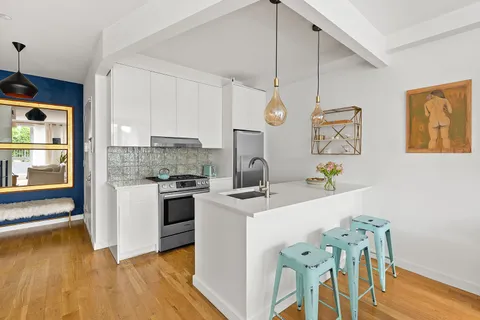 a kitchen with a table and chairs in it