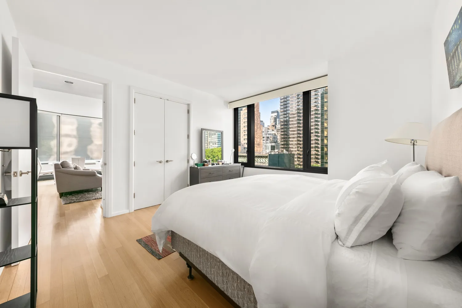 a bedroom with a bed and a large window