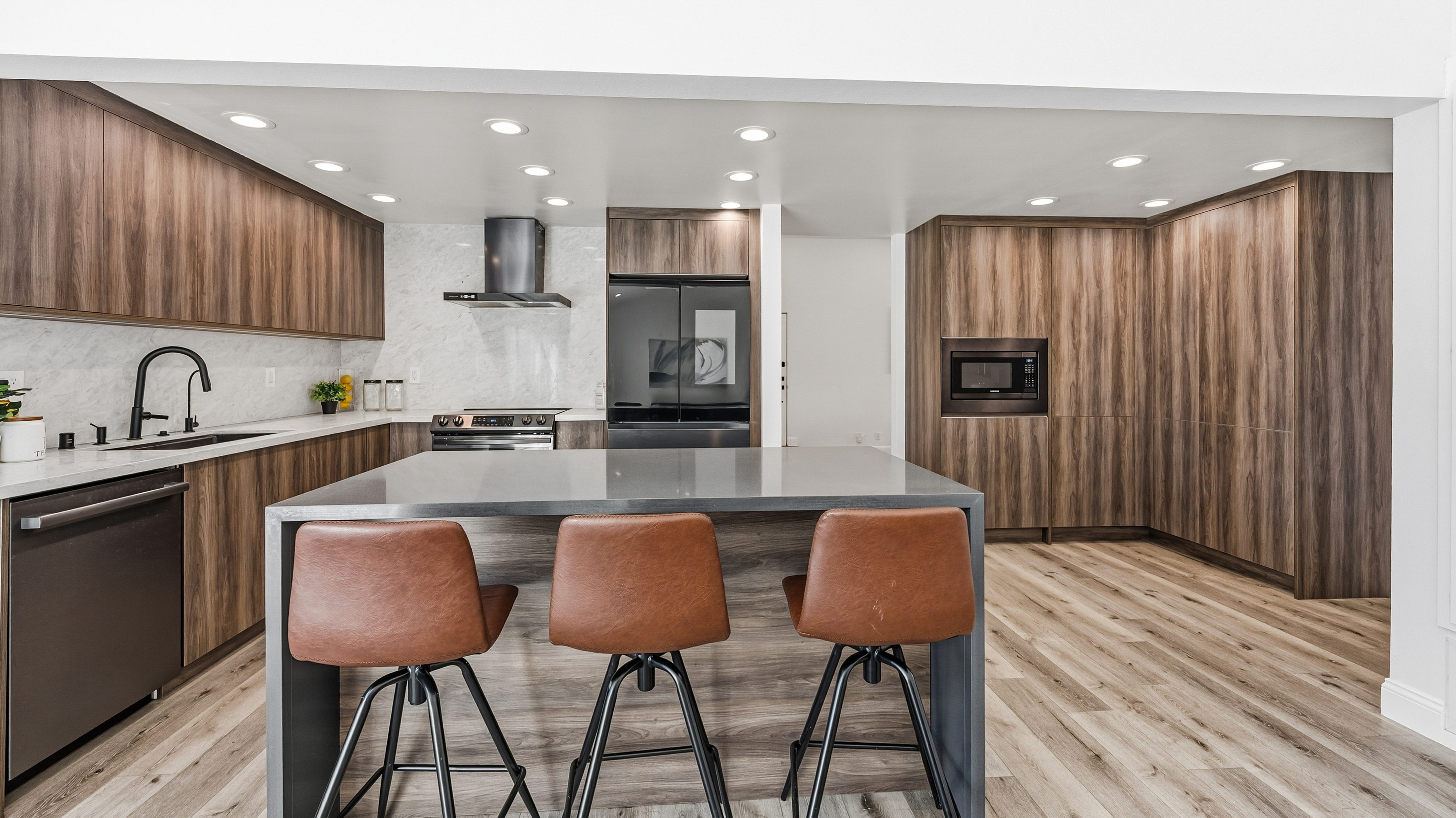2430 North Greensward Street Simi Valley, CA 93065 - Photo 4 of 6 a kitchen with kitchen island granite countertop wooden cabinets and a refrigerator