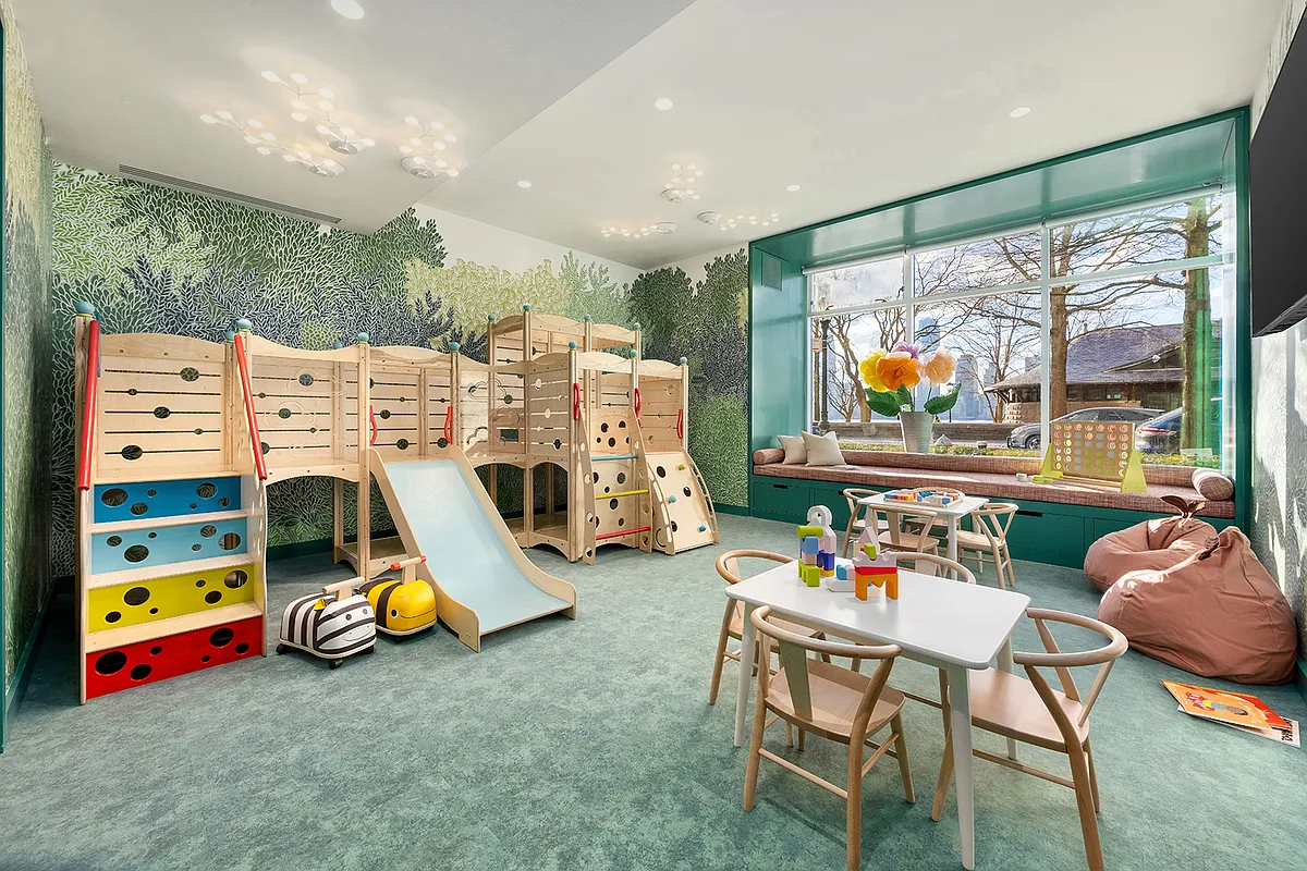 20 River Terrace, Unit 14C Manhattan, NY 10282 - Photo 12 of 18 a play room with furniture and a floor to ceiling window