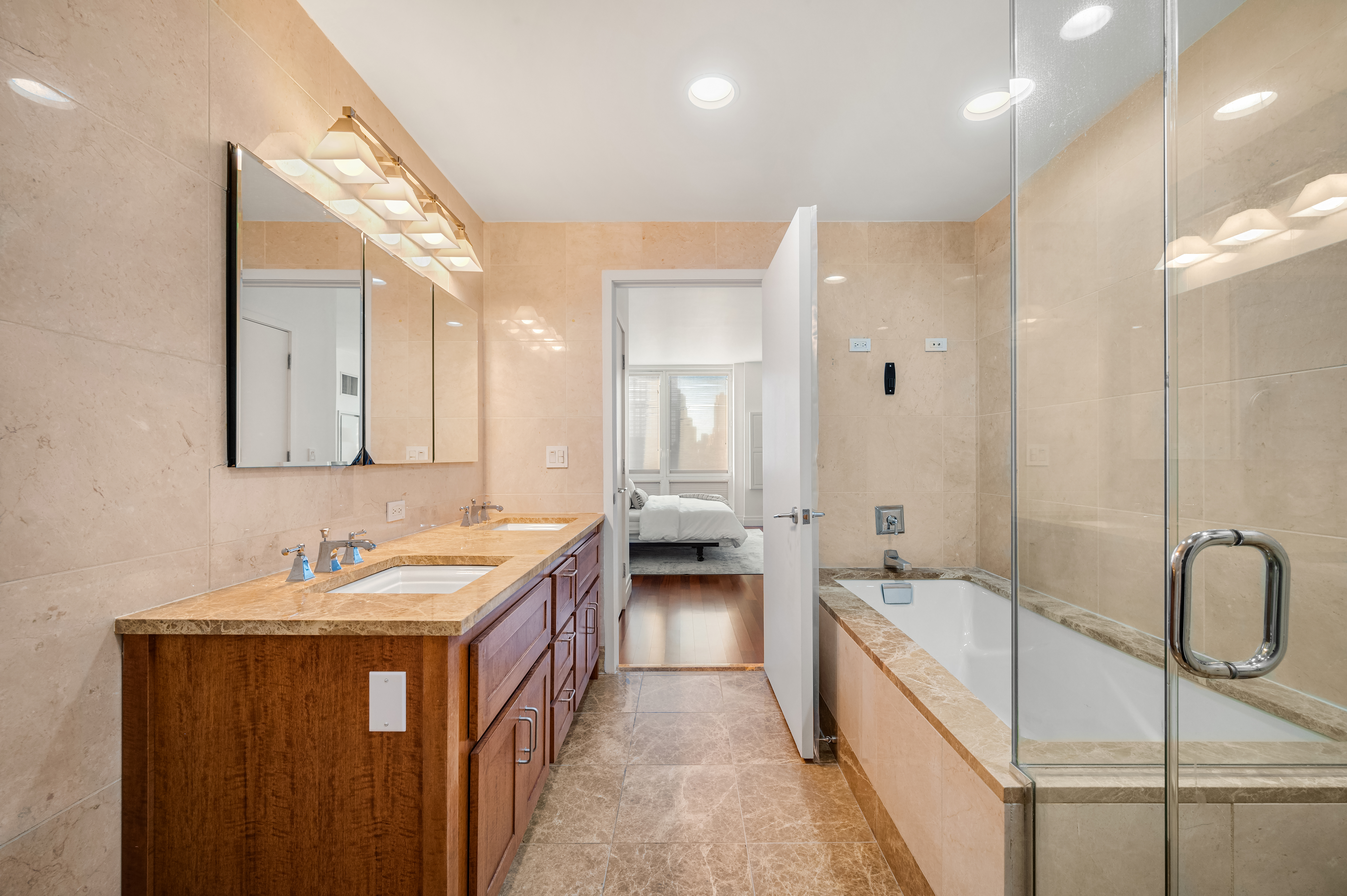 45 Park Avenue, Unit 1801 Manhattan, NY 10016 - Photo 7 of 12 a bathroom with a double vanity sink and mirror