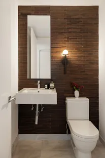 a bathroom with a sink a toilet and mirror